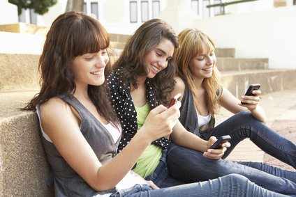 Loyalty Programs Millennials | Group of students looking at their phones
